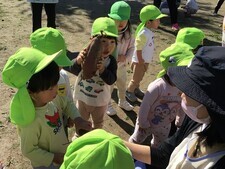 大きなさつまいもを得意気に見せる1歳の男の子