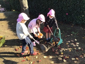 落ち葉はきをする5歳児