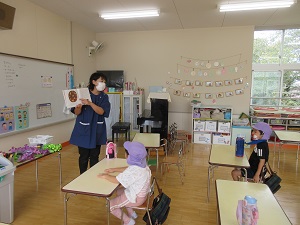 写真：カブトムシの赤ちゃんが生まれた話を聞く年長児